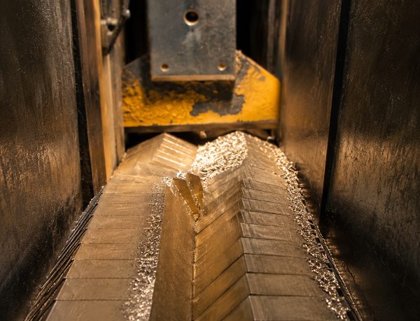 Close-up of the saw blade cutting through stacked metal bar at Seng Huat Metalplex Close-up of the saw blade cutting through stacked metal bar at Seng Huat Metalplex
